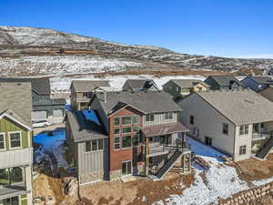 Snowy aerial view featuring a mountain view