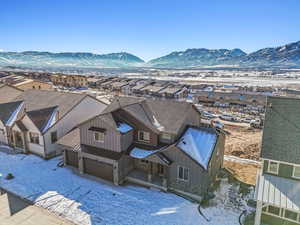 Snowy aerial view featuring a mountain view