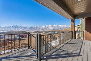 Snow covered back of property with a mountain view