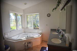 Bathroom featuring vaulted ceiling and a jet tub to relax, seperate shower