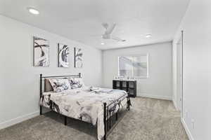 Bedroom with ceiling fan and carpet floors