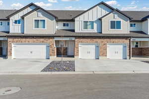 Townhome / multi-family property featuring a garage