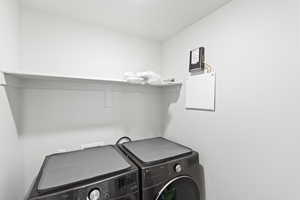 Laundry room with washing machine and clothes dryer