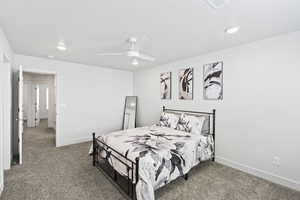 Carpeted bedroom with ceiling fan