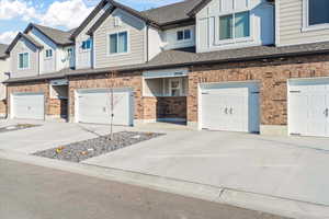 Townhome / multi-family property featuring a garage