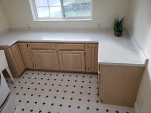 Kitchen featuring light brown cabinets