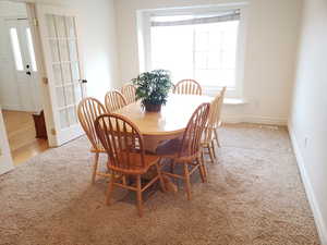 Dining room with light colored carpet