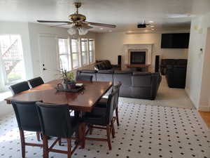 Dining room featuring ceiling fan and light carpet