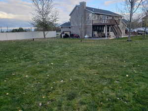 View of backyard and back of home featuring a deck and a patio