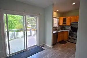 Kitchen with vaulted ceiling, decorative backsplash, sink, light wood-type flooring, and stainless steel appliances