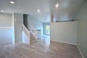 Spare room featuring light wood-type flooring and a textured ceiling