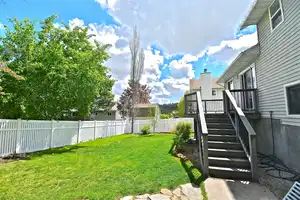 View of yard with a wooden deck