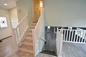 Stairs featuring hardwood / wood-style flooring