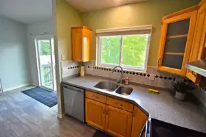 Kitchen featuring decorative backsplash, sink, dishwasher, and stove