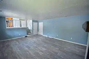 Unfurnished living room with a textured ceiling and hardwood / wood-style flooring