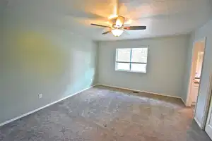 Master Bedroom. Empty room featuring a textured ceiling, ceiling fan, and carpet flooring