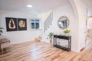 Foyer with light hardwood / wood-style floors