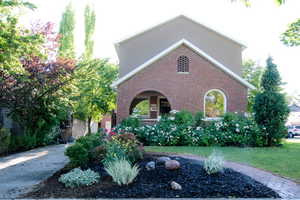 View of front of property featuring a front yard in the summer