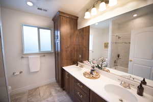 Full bathroom featuring toilet, vanity, and tiled shower / bath