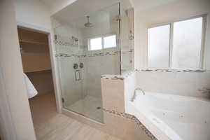 Bathroom with tile patterned flooring and separate shower and tub