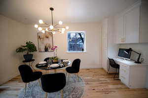 Dining area with a chandelier and light hardwood / wood-style flooring