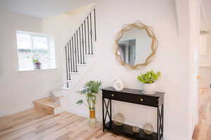 Stairs featuring hardwood / wood-style flooring