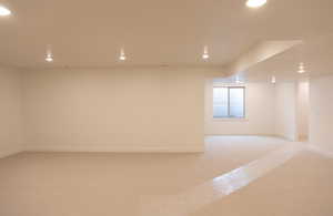 Empty room featuring light colored carpet