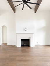 Details with ceiling fan, wood-type flooring, and beamed ceiling