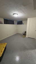 Basement featuring a textured ceiling