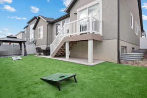 Rear view of house featuring a gazebo, a yard, and a patio