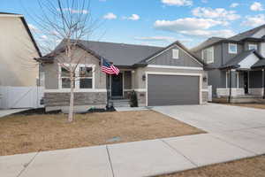 Craftsman-style house with a garage and a front yard