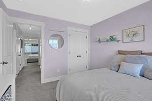 Carpeted bedroom with a closet