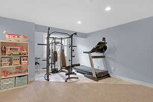 Exercise room featuring light carpet