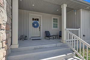 Doorway to property featuring a porch