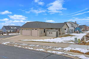 View of front of property featuring a shed, a garage, and a playground