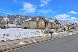 View of front of house featuring central AC, a mountain view, and a playground