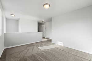 Unfurnished room with light colored carpet