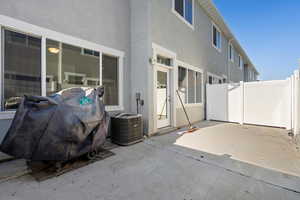 View of patio / terrace with cooling unit and a grill