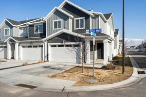 View of front facade featuring a garage and a mountain view