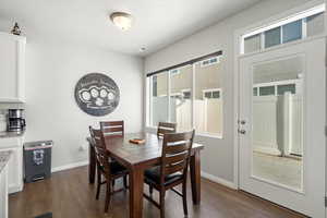 Dining area with a textured ceiling and dark hardwood / wood-style flooring