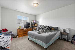 Carpeted bedroom featuring a textured ceiling