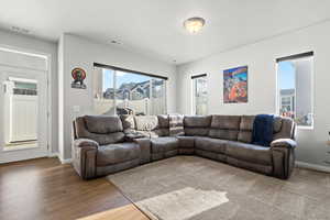 Living room featuring hardwood / wood-style flooring and a textured ceiling