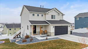 View of front of house with a front yard and a garage