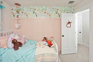 Bedroom featuring light colored carpet