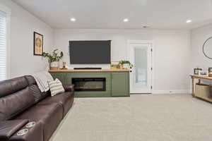 Living room featuring light colored carpet and a wealth of natural light