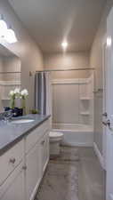 Full bathroom featuring toilet, vanity, and shower / bath combo