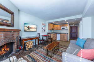 Living room with sink and a brick fireplace