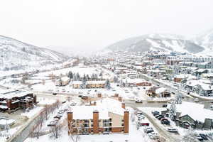 Snowy aerial view featuring a mountain view