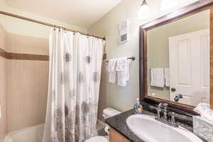 Full bathroom featuring toilet, vanity, and shower / bath combo