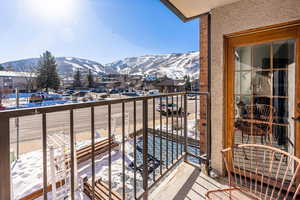 Snow covered back of property featuring a mountain view